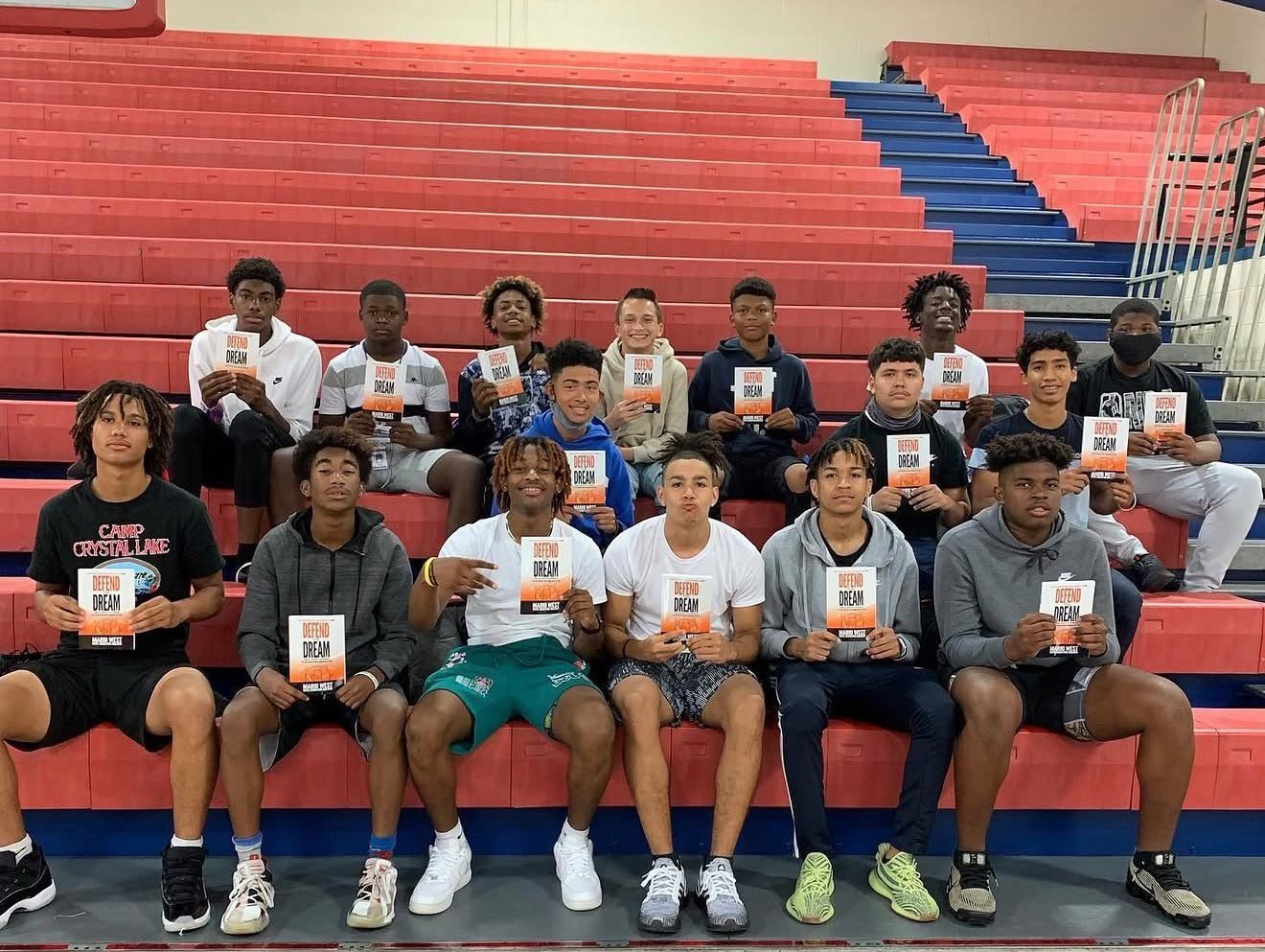 A high school basketball team holding copies of Mario West’s book